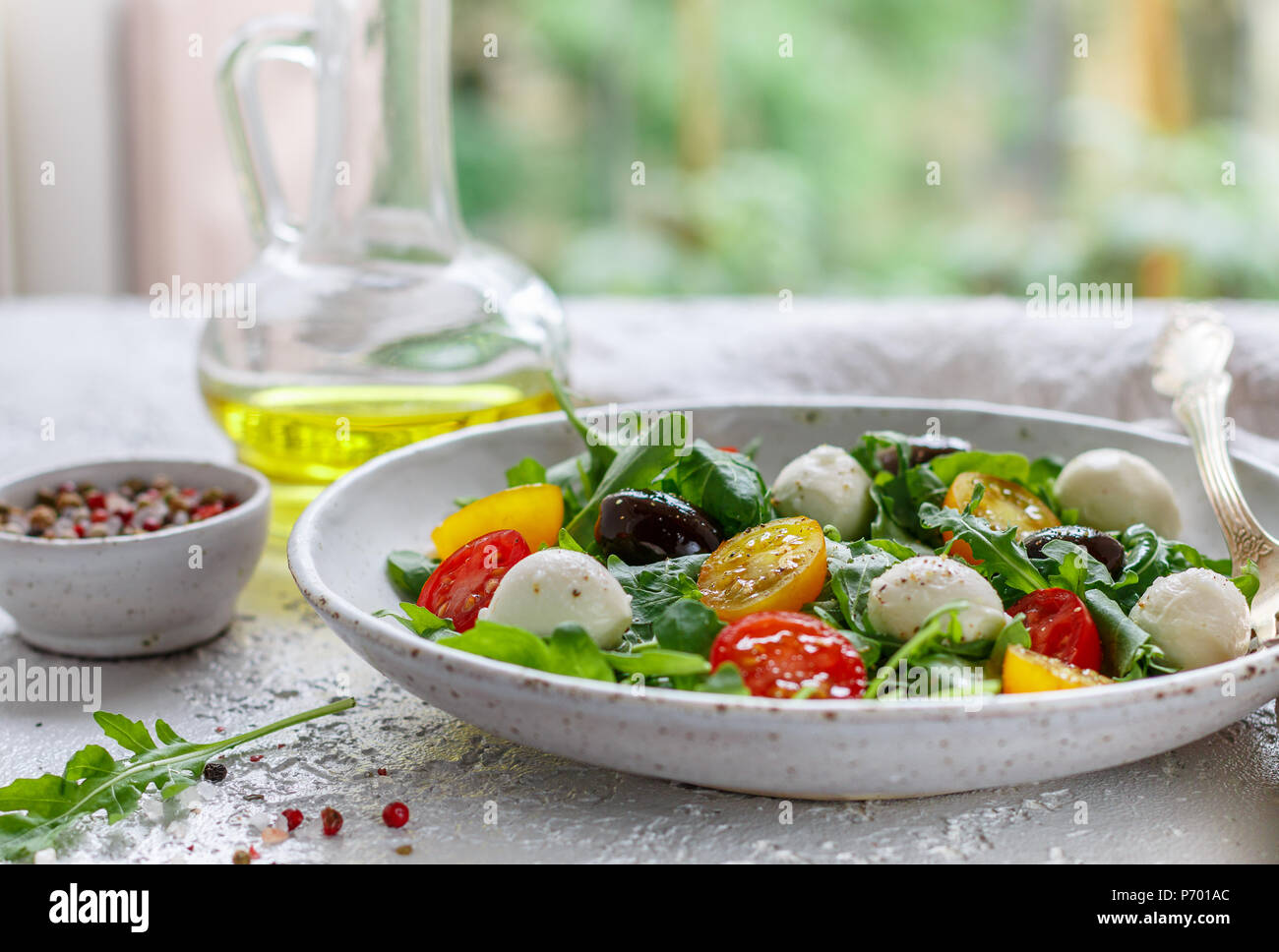 Fresh summer salad with arugula, yellow and red cherry tomatoes