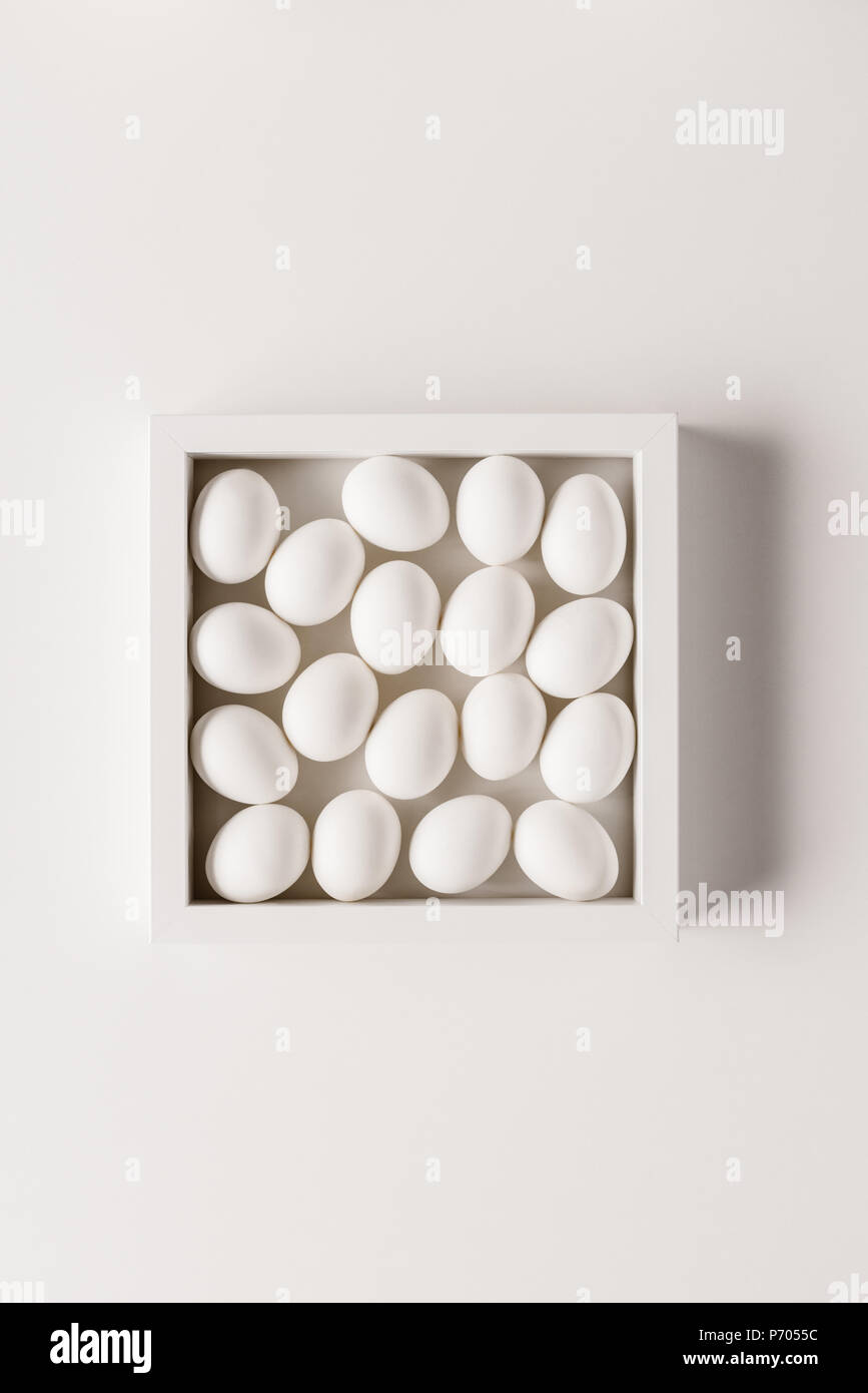 top view of chicken eggs in frame on white background Stock Photo - Alamy