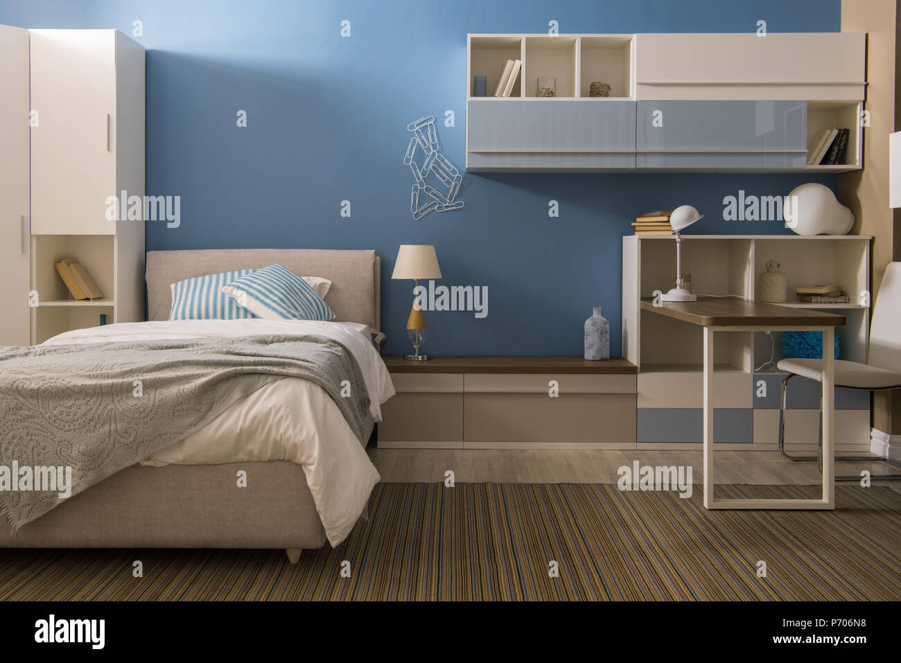 Light Bedclothes On Bed In Cozy Bedroom In Blue Tones Stock