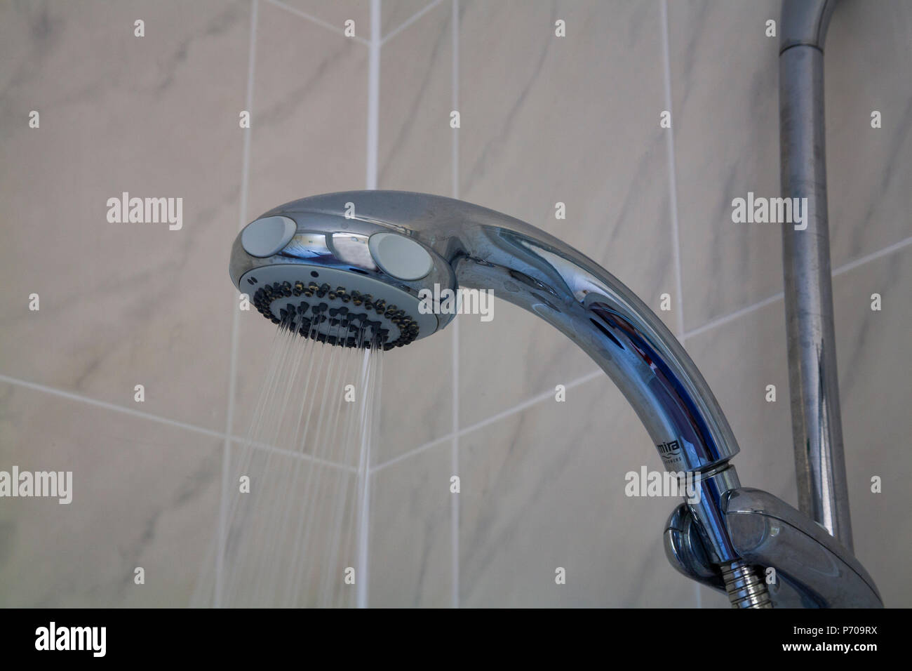 Shower head set on Eco setting to reduce metered water during period of water shortage Stock Photo