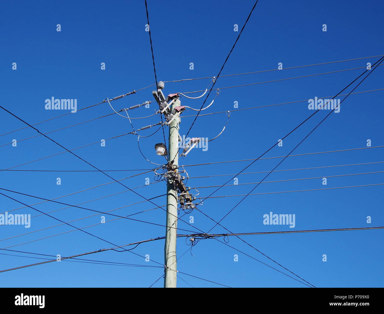 Free standing residential power line mast with wires in all directions, Melbourne 2018 Stock Photo