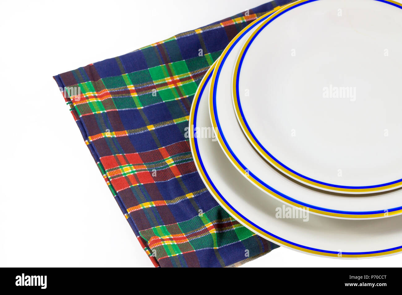 Empty plate on towel in white background. Stock Photo