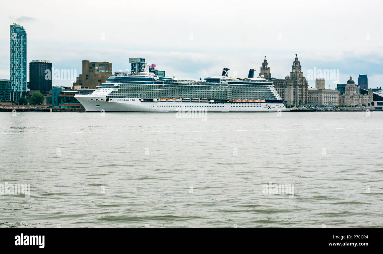 Celebrity Eclipse cruise ship docked at Pier Head  next to the Three Graces, Liverpool, England, UK, seen from River Mersey Stock Photo
