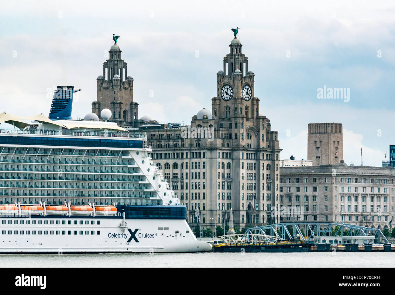 View of clock towers of Royal Liver building with Liver Birds and UK's largest clocks, Celebrity Cruise ship, Pier Head, Liverpool, England, UK Stock Photo