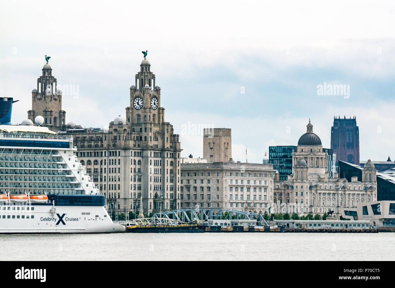 View of clock towers of Royal Liver building with Liver Birds and UK's largest clocks, Celebrity Cruise ship, Pier Head, Liverpool, England, UK Stock Photo