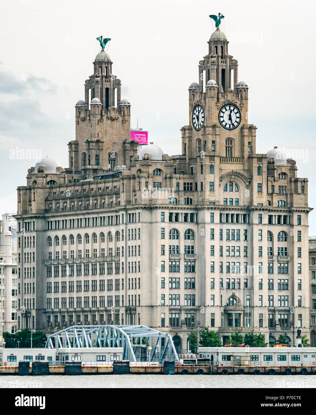 View of clock towers of Royal Liver building with cormorant Liver Birds and UK's largest clocks, Pier Head, Liverpool, England, UK Stock Photo