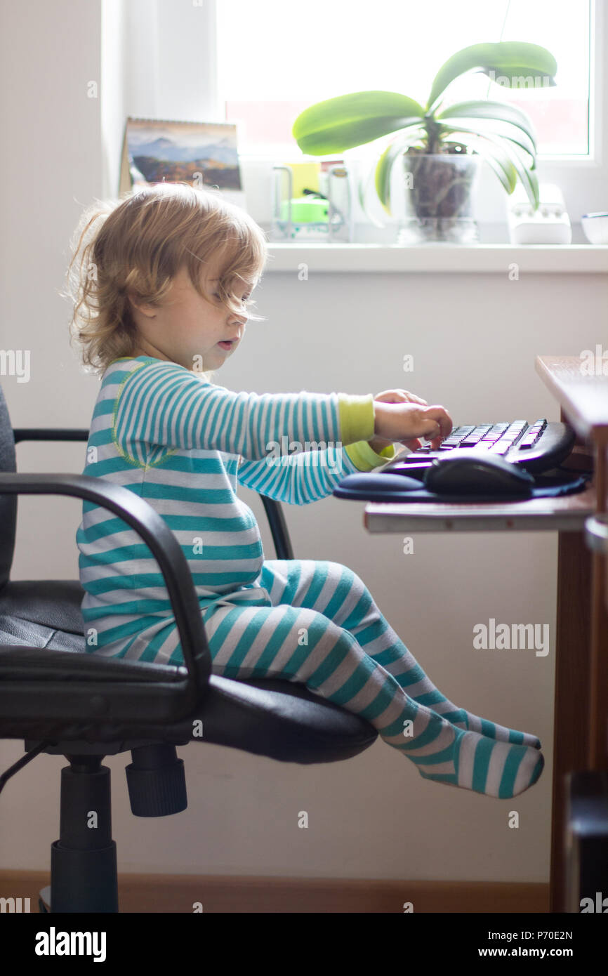 Childhood and technology ,Two years child using computer at home Stock ...