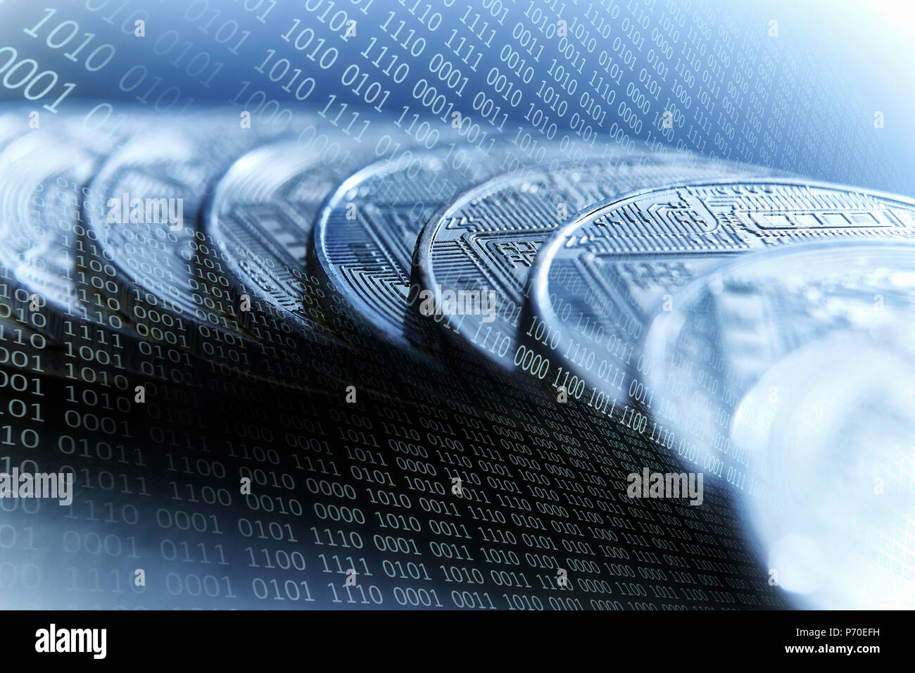 Bitcoins on blue binary code background Stock Photo