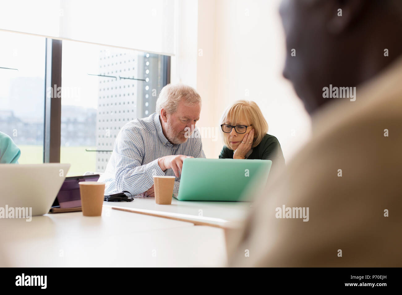 Senior business people using laptop in conference room meeting Stock Photo