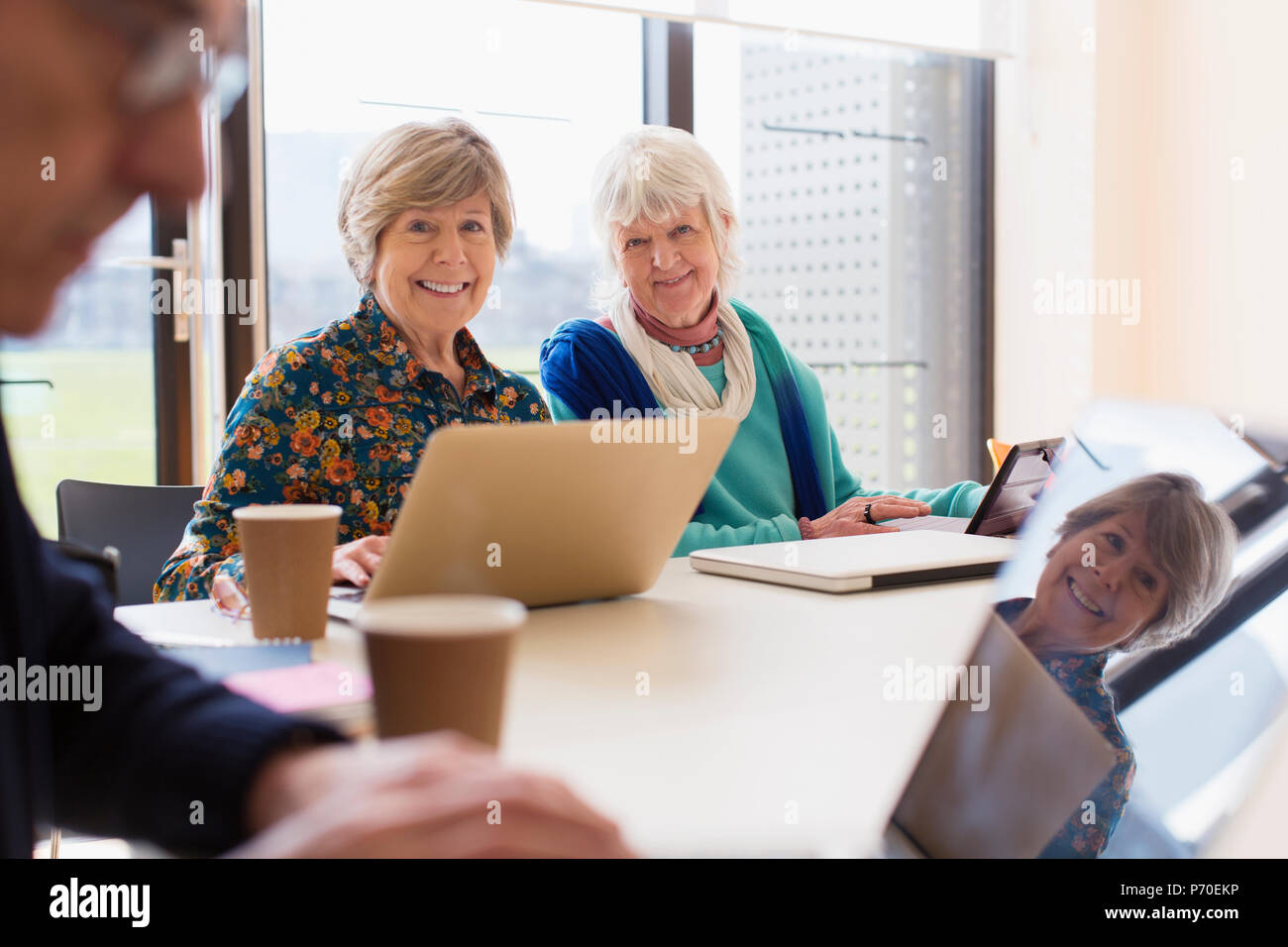 Portrait smiling, confident senior businesswomen in conference room meeting Stock Photo