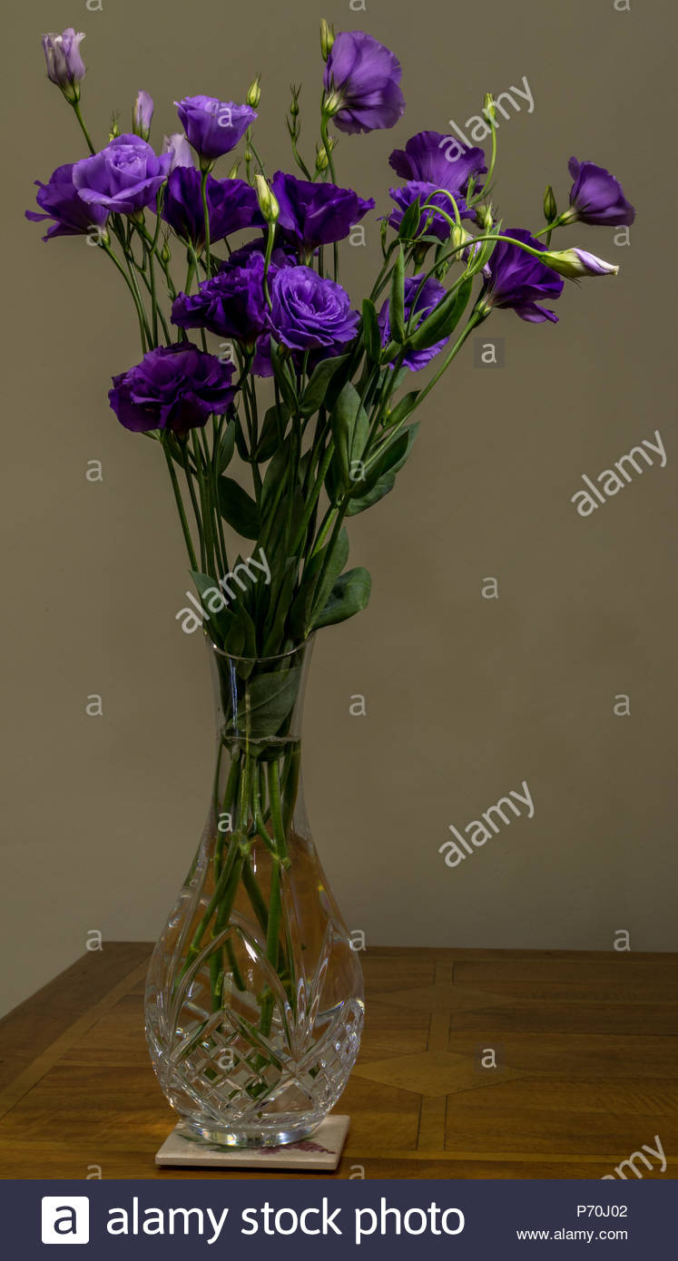 A Bouquet Of Lisianthus Purple Flowers In A Cut Glass Crystal Vase