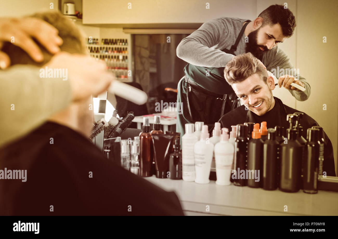 adult russian male hairdresser doing haircut for male client at hair salon Stock Photo Alamy