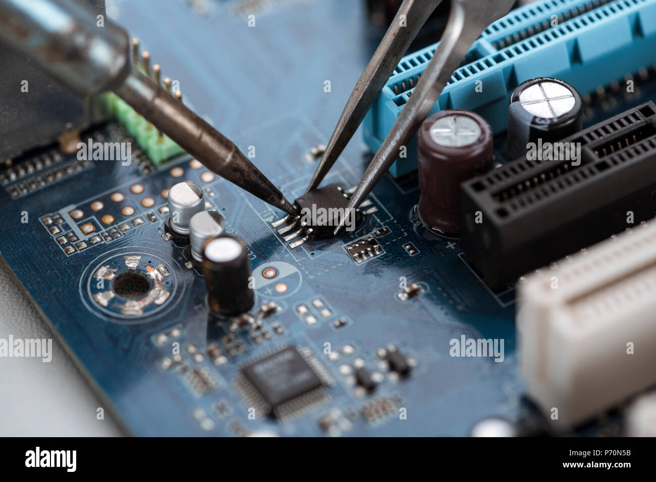 Soldering typical desktop computer baseboard closeup view Stock Photo