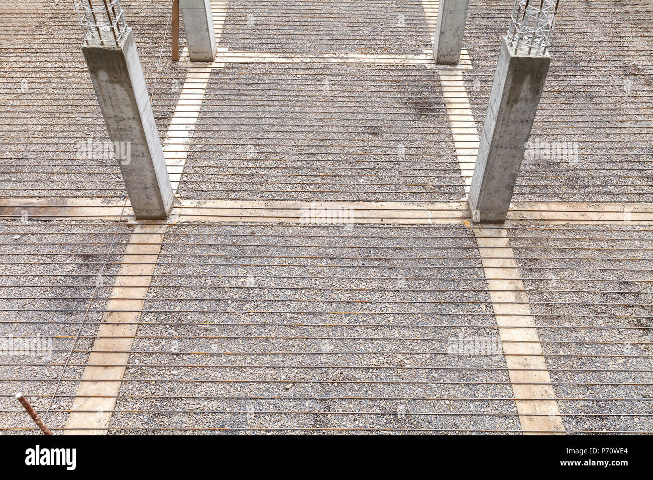 A grid of reinforcement laid on the surface ready for pouring concrete