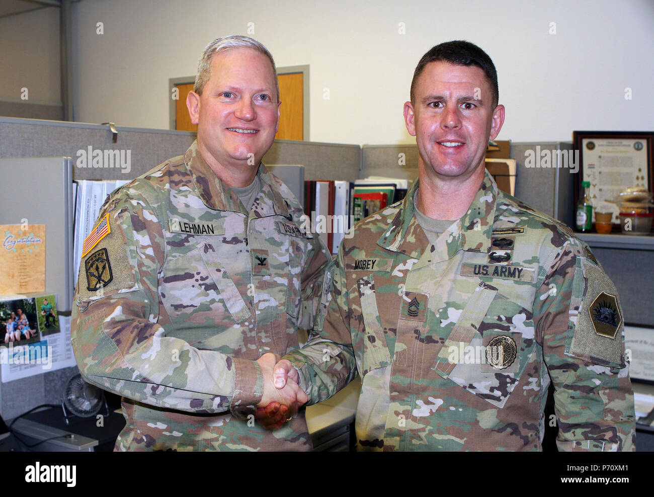 Master Sgt. Brandon S. Morey, right, assistant inspector general at the California National Guard’s Inspector General’s Office, is congratulated by Col. Robert J. Lehman, State Inspector General, May 12 after earning runner-up in the prestigious Dept. of the Army Inspector General Noncommissioned Officer of the Year competition recently. Morey, of Dixon, California, took top honors in April’s National Guard Bureau Inspector General Soldier of the Year to earn the shot at the U.S. Army contest. Stock Photo
