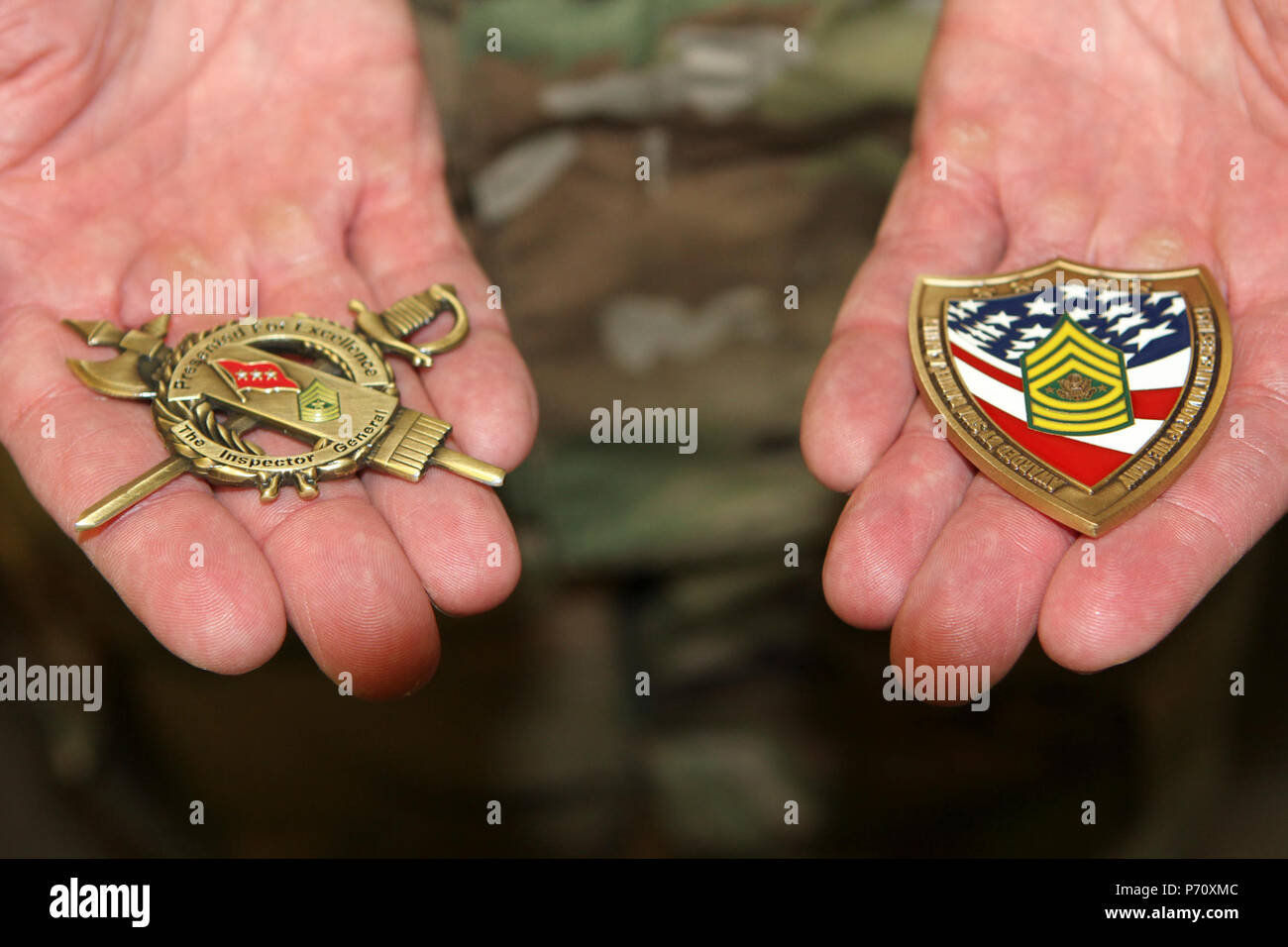 The hands of Master Sgt. Brandon S. Morey, assistant inspector general at the California National Guard’s Inspector General’s Office, display the coins earned during April’s National Guard Inspector General Noncommissioned Officer of the Year competition, where he earned top honors. Stock Photo