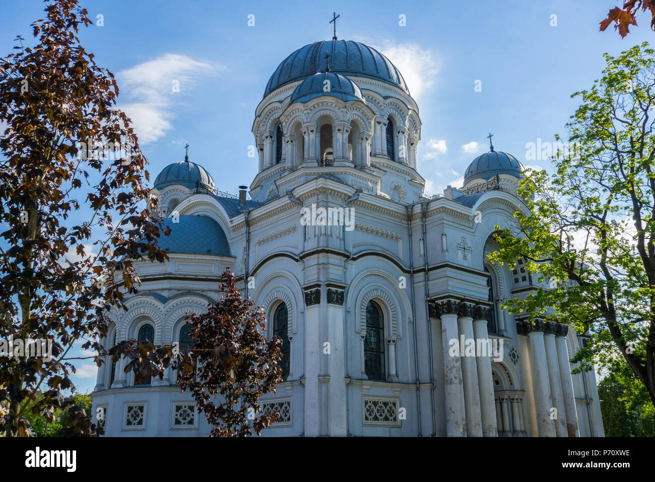 Lithuania, Side view between trees on ancient Sankt Michael the Archangel Church in Kaunas Stock Photo