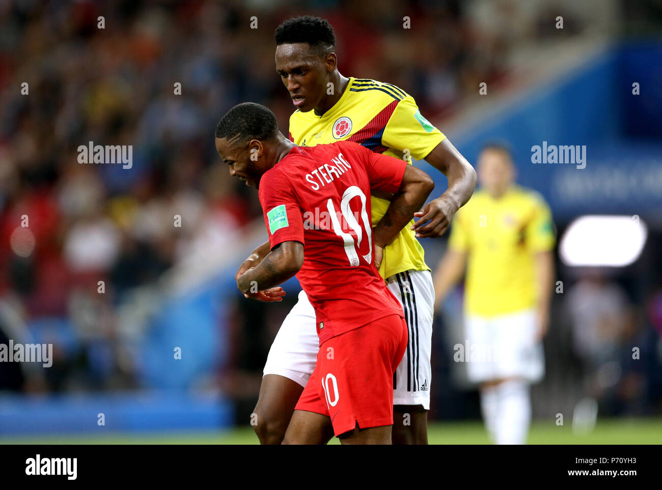 England's Raheem Sterling (front) and Colombia's Yerry Mina appear to clash during the FIFA World Cup 2018, round of 16 match at the Spartak Stadium, Moscow. Stock Photo