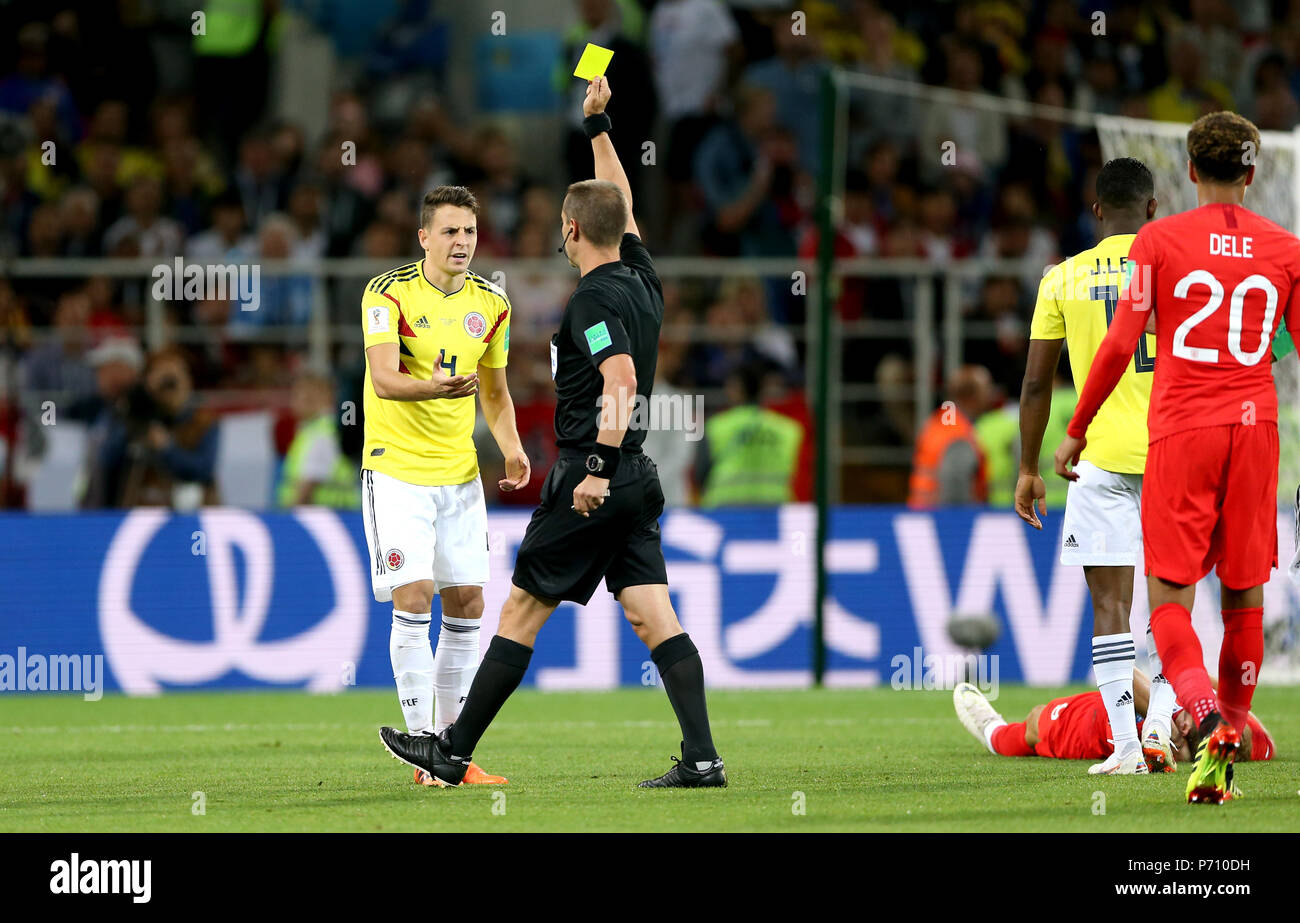 Referee Mark Geiger shows Colombia's Santiago Arias a yellow card for a foul on England's Harry Kane (right, floor) during the FIFA World Cup 2018, round of 16 match at the Spartak Stadium, Moscow. Stock Photo