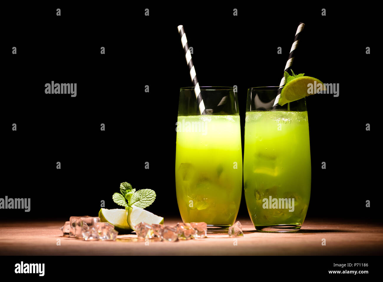 alcohol mojito cocktails with lime and ice cubes on table Stock Photo