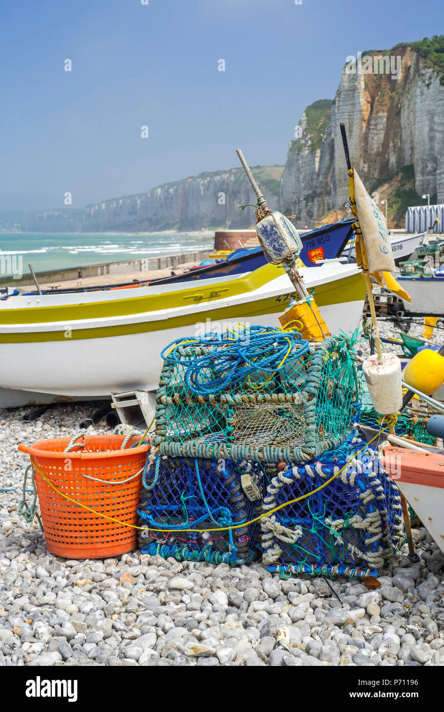Traditional fishing boats / caïques and lobster pots on beach and sea cliffs at seaside resort Yport, Normandy, Seine-Maritime, Côte d'Albâtre, France Stock Photo