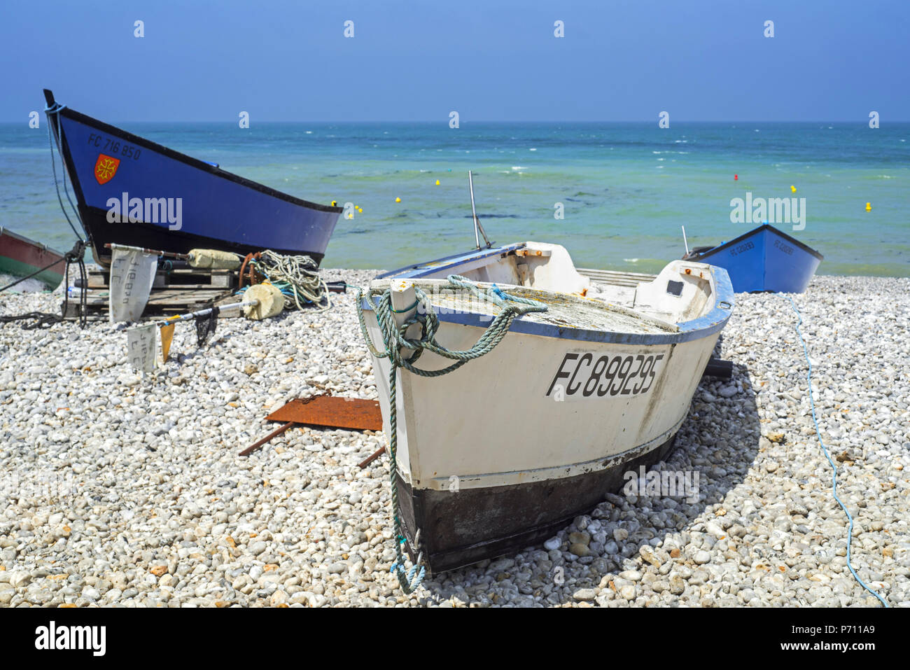 Traditional fishing boats / caïques on shingle beach at seaside resort Yport, Normandy, Seine-Maritime, Côte d'Albâtre, France Stock Photo