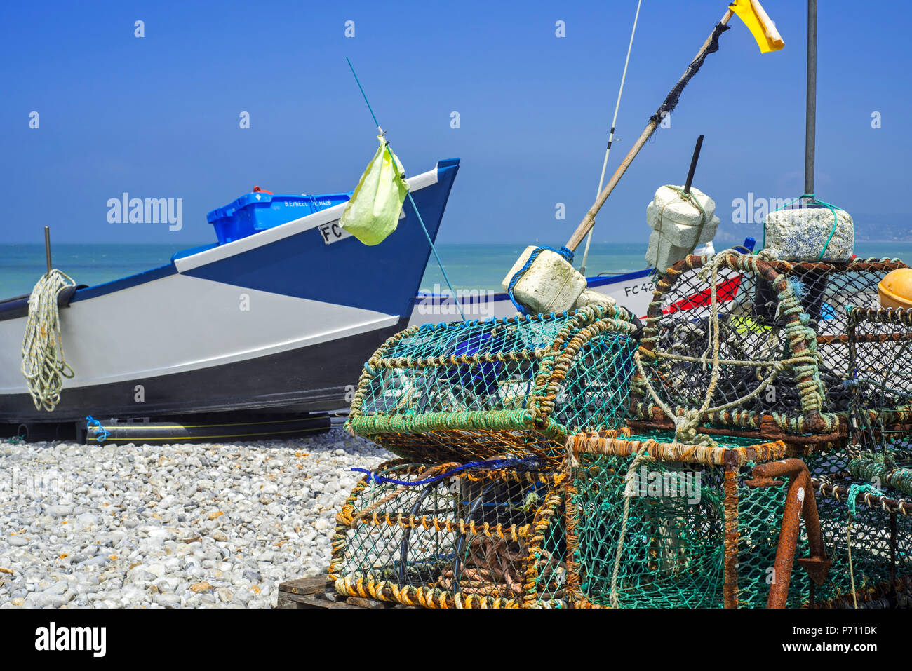 Traditional fishing boats / caïques and lobster pots on beach at seaside resort Yport, Normandy, Seine-Maritime, Côte d'Albâtre, France Stock Photo