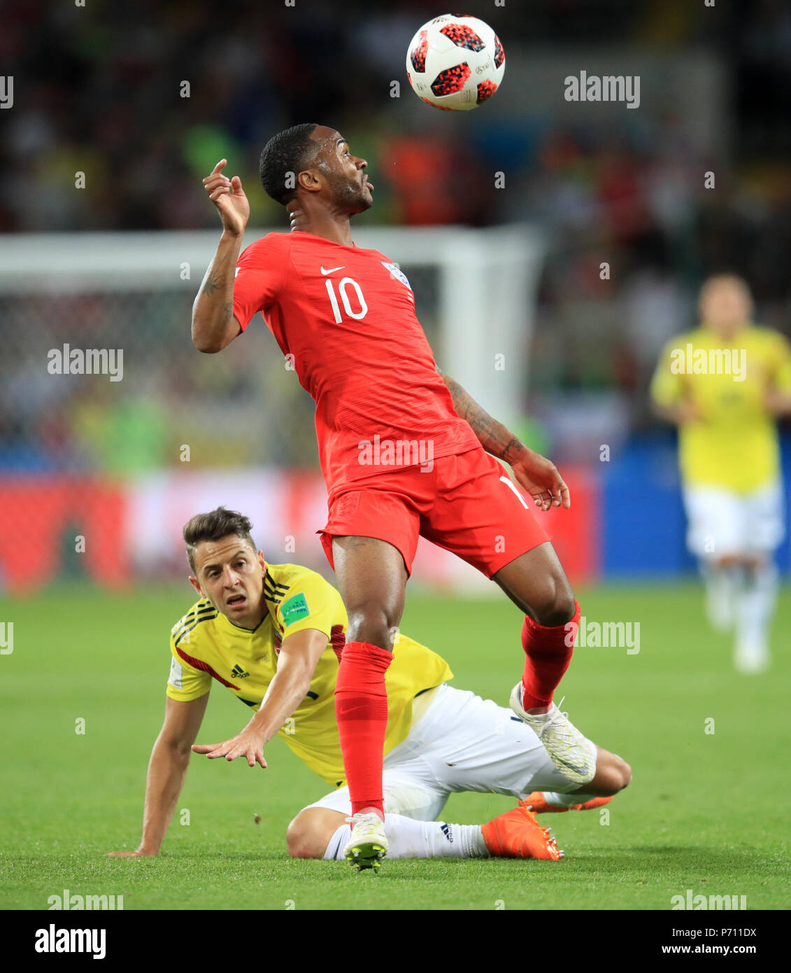 Colombia's Santiago Arias (left) and England's Raheem Sterling battle for the ball during the FIFA World Cup 2018, round of 16 match at the Spartak Stadium, Moscow. Stock Photo