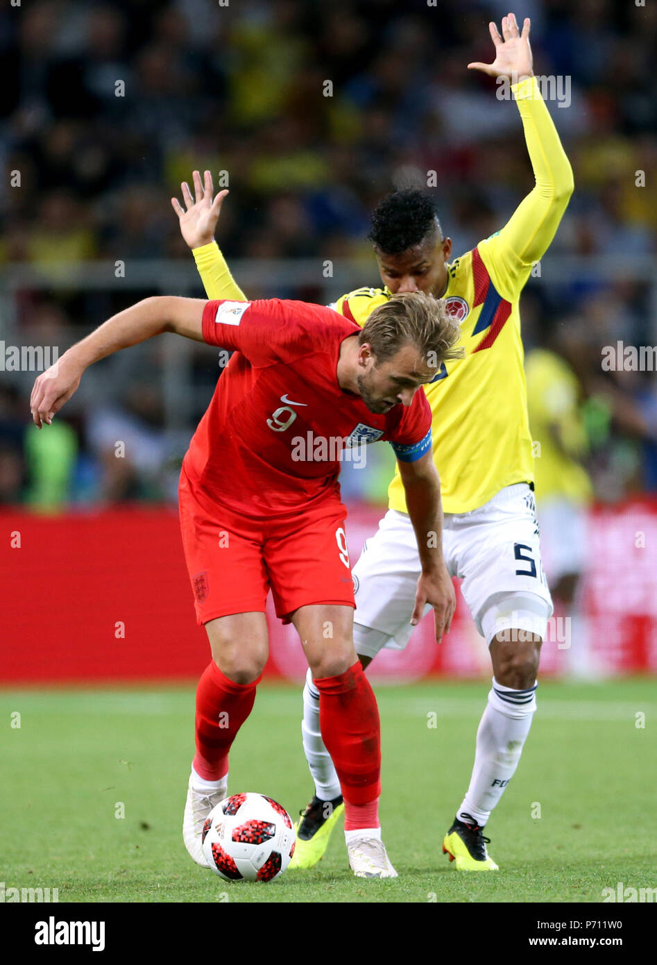 England's Harry Kane (front) and Colombia's Wilmar Barrios battle for the ball during the FIFA World Cup 2018, round of 16 match at the Spartak Stadium, Moscow. Stock Photo