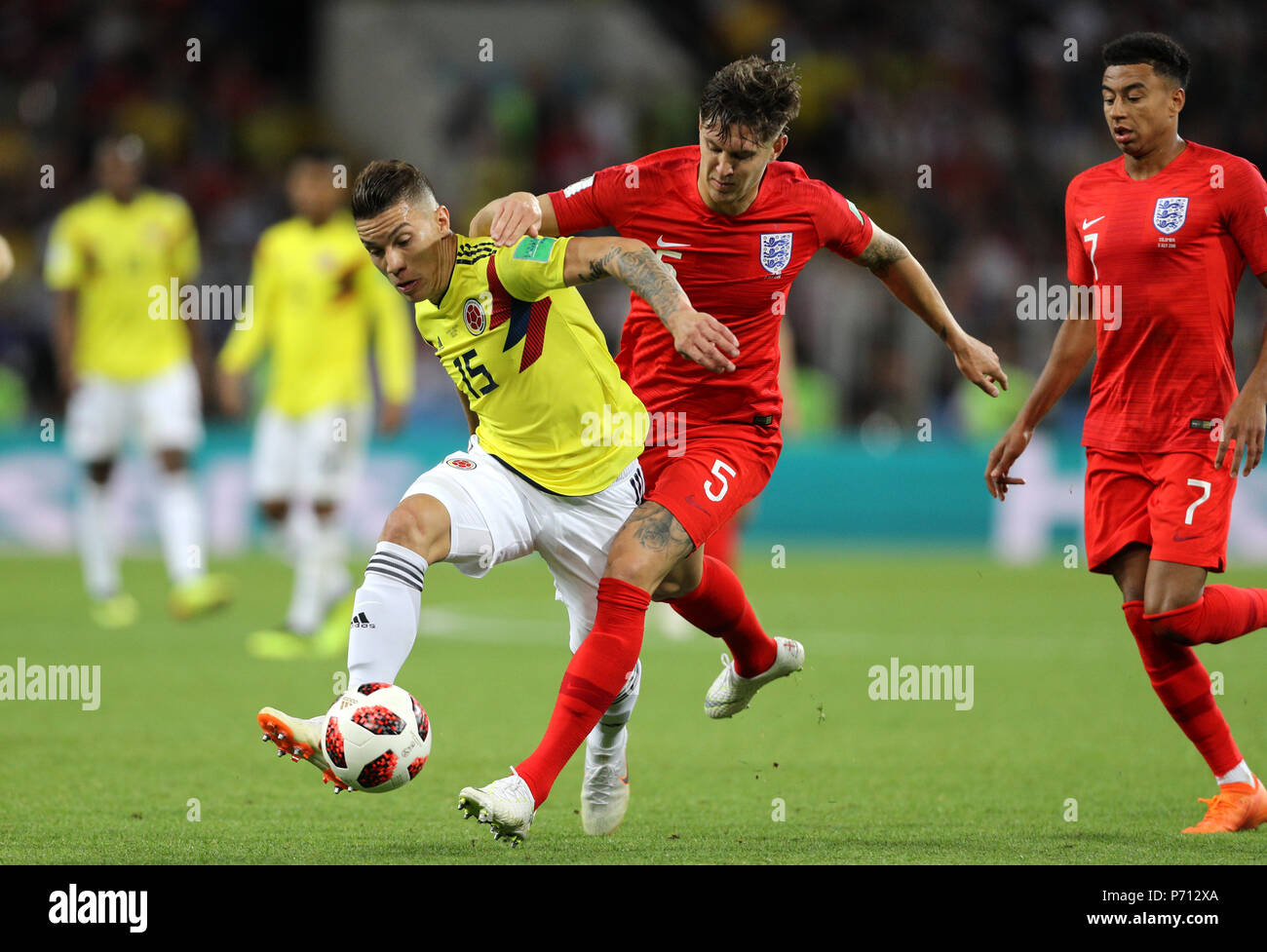 Colombia's Mateus Uribe (left) and England's John Stones battle for the ball during the FIFA World Cup 2018, round of 16 match at the Spartak Stadium, Moscow. Stock Photo