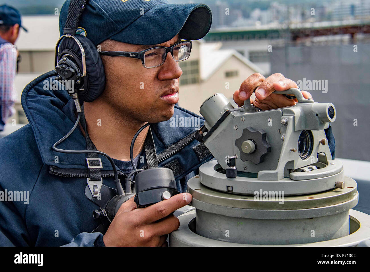 SASEBO, Japan (May 11, 2017) Quartermaster 3rd Class Brandon Martin takes bearing readings aboard the amphibious transport dock USS Green Bay (LPD 20) as the ship returns to its forward-deployed base of Sasebo, Japan during a Mid-Cycle Inspection (MCI). Green Bay, assigned to Commander, Amphibious Squadron 11, is conducting its MCI, which is conducted at the mid-year point prior to the Board of Inspection and Survey (INSURV) and is used to inspect and assess the material conditions of a ship. Stock Photo