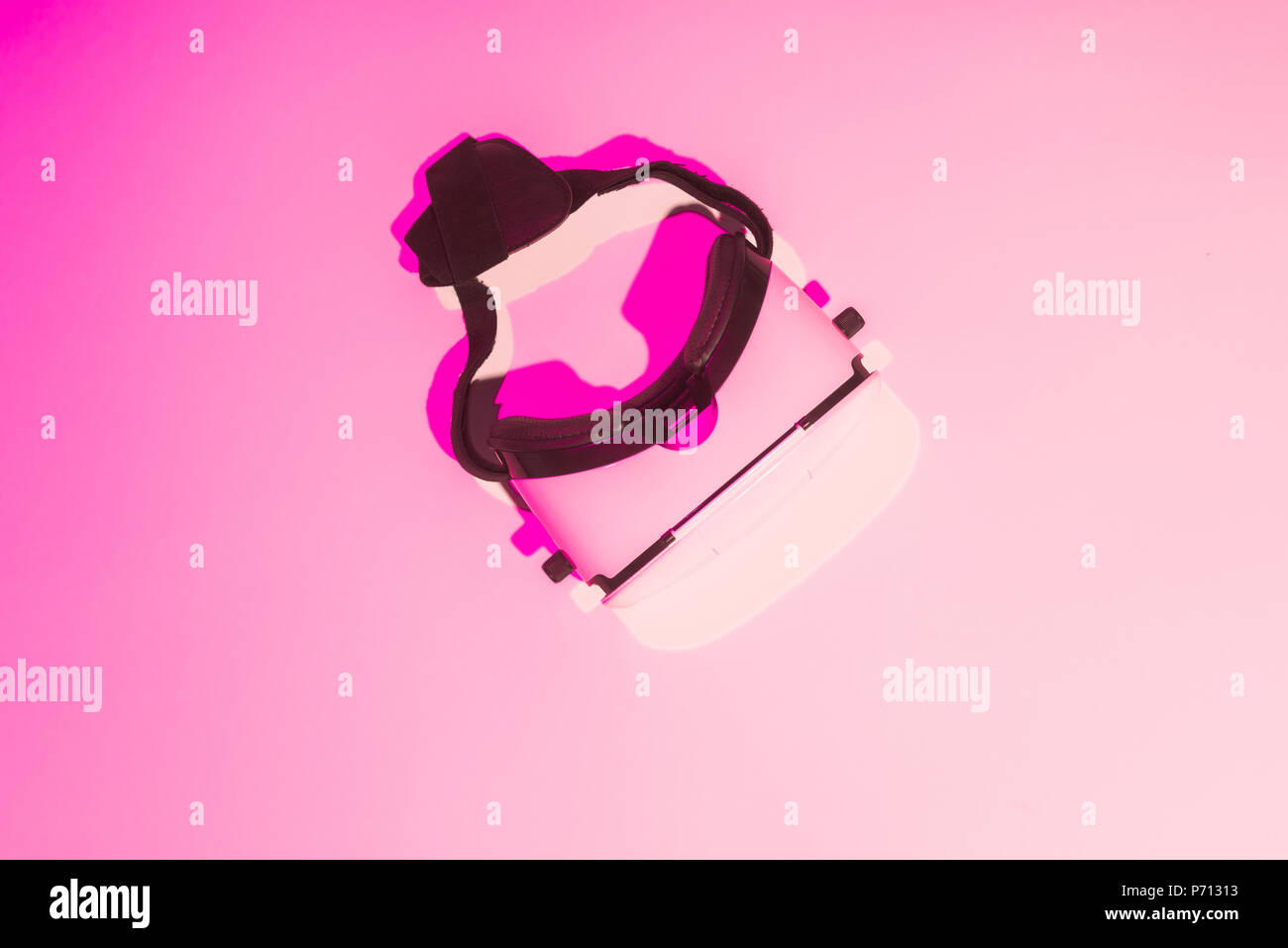 pink toned picture of virtual reality headset on table Stock Photo - Alamy