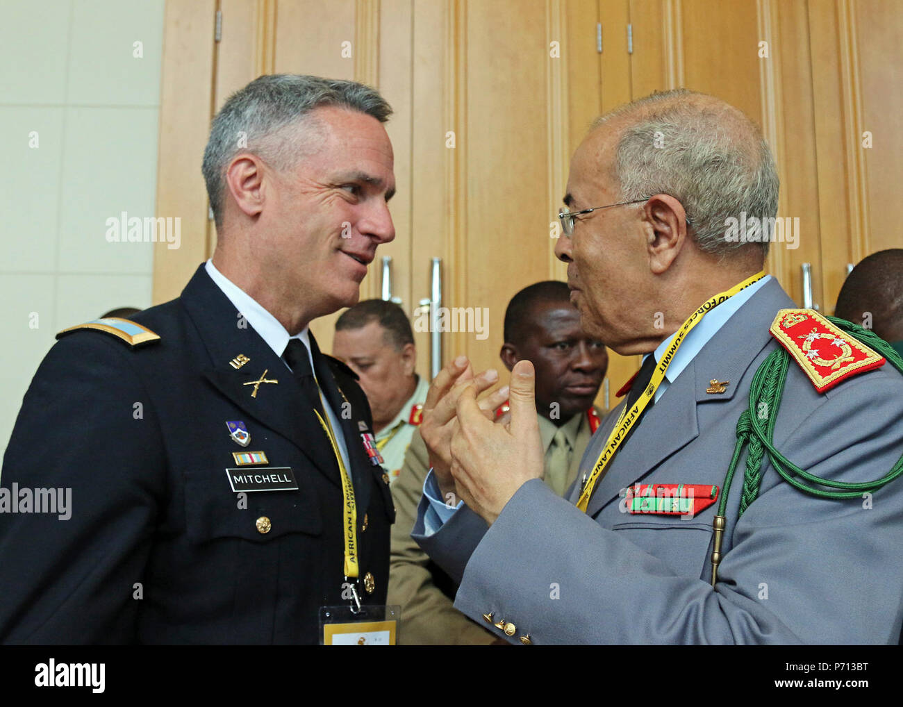 Lt. Col. Tim Mitchell, a foreign area officer at the National Defense University, and Lt. Gen. Mohammed Zeggaoui, inspector general of armor for Morocco, socialize during African Land Forces Summit, in Lilongwe, Malawi, May 11, 2017. ALFS is an annual, weeklong seminar bringing together land force chiefs from across Africa for candid dialog to discuss and develop cooperative solutions to regional and transregional challenges and threats. Stock Photo