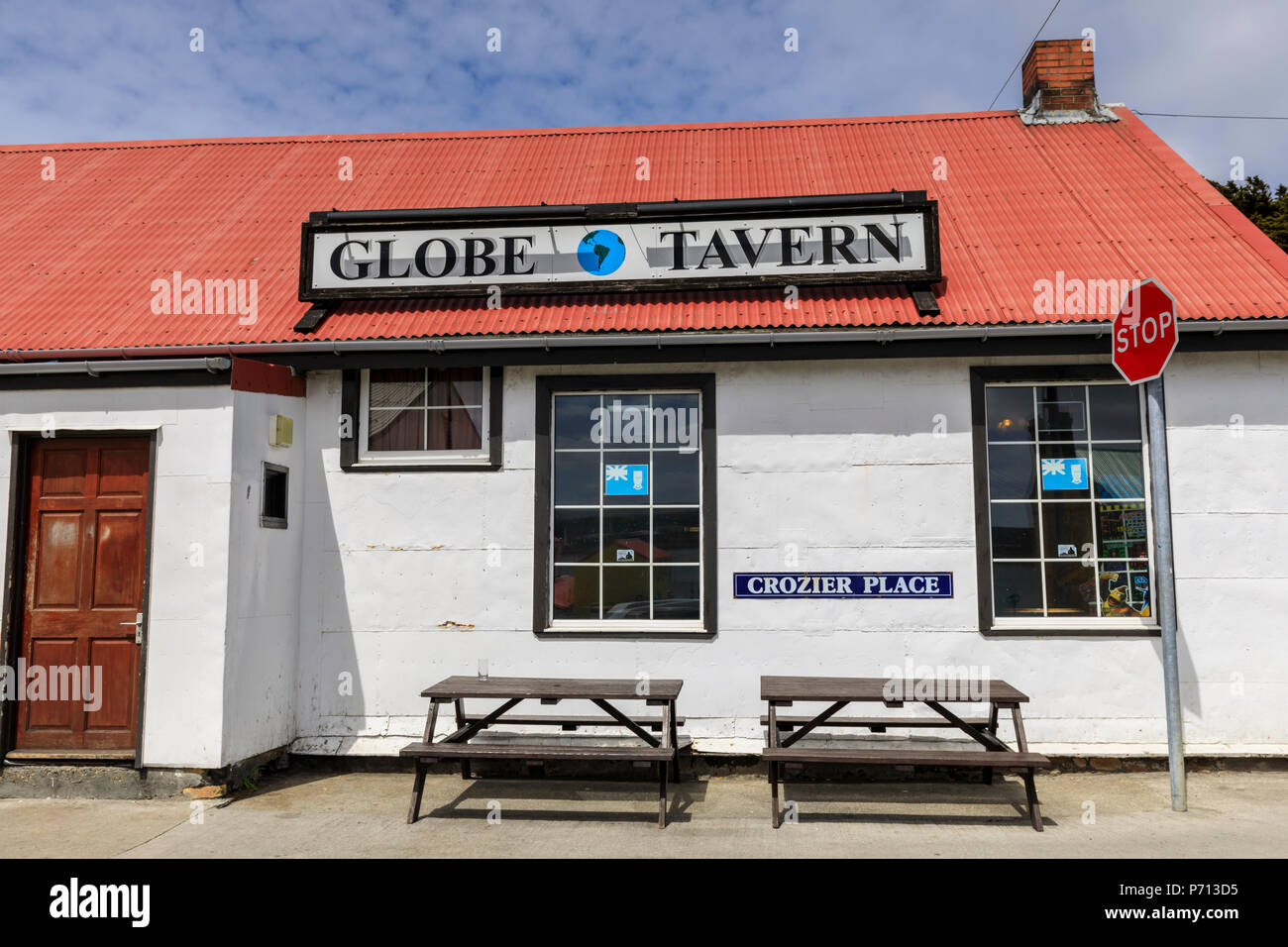 Stop sign and Globe Tavern British Pub, picnic tables, Stanley, Port Stanley, Falkland Islands, South America Stock Photo