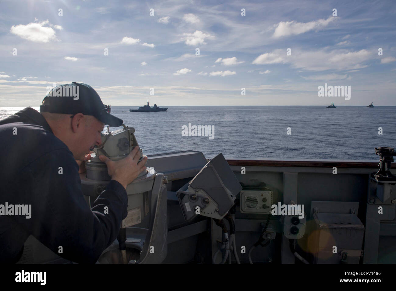 SOUTH CHINA SEA (May 11, 2017) Lt. Cmdr. Joseph McDonald, a Detroit native, uses a telescopic alidade to track Republic of Singapore ship RSS Intrepid (FFS 69), Royal Thai Navy ship HTMS Naresuan (FFG 421), and Independence-class littoral combat ship USS Coronado (LCS 4) aboard Arleigh Burke-class guided-missile destroyer USS Sterett (DDG 104) during a divisional tactics exercise in support of the Cooperation Afloat Readiness and Training (CARAT) multilateral exercise. CARAT is a series of annual maritime exercises aimed at strengthening partnerships and increasing interoperability through bil Stock Photo