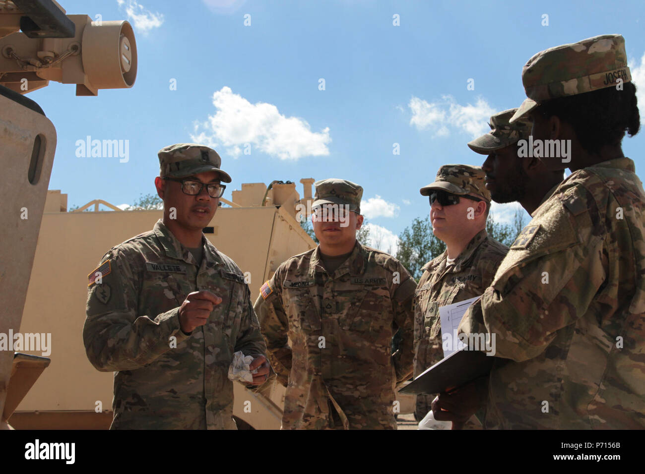Sgt. 1st Class Joel Vallete, signal section chief of Headquarters Company, 1st Battalion, 8th Infantry Regiment, 3rd Armored Brigade Combat Team, 4th Infantry Division, goes over the safety features on a M113 Command Post Vehicle with a few of his soldiers on May 11, 2017 at Mihail Koglanicenau Air Base, Romania. Vallete spends a lot of his time in and out of the field with his Soldiers training them in their on the job skills, as well as the art of boxing. Stock Photo