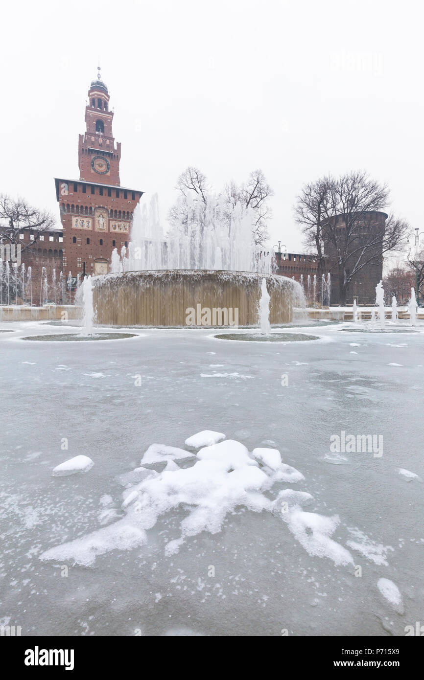 A iced fountain and Sforzesco Castle after a snowfall, Milan, Lombardy, Northern Italy, Italy, Europe Stock Photo