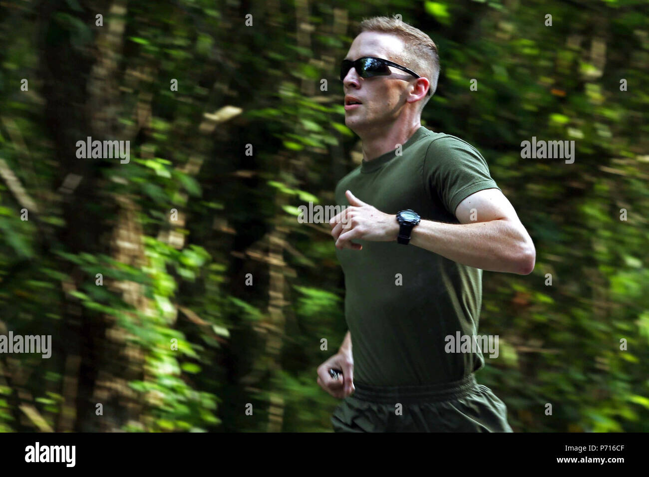 U.S. Marine Corps Lance Cpl. Austin Livingston, combat photographer, Headquarters and Support Battalion, Marine Corps Installations East, participates in a memorial run to honor fallen combat camera members, Camp Lejeune, N.C., May 11, 2017. Cpl. Sara Medina, a combat photographer, and Lance Cpl. Jacob Hug, a combat videographer, gave the ultimate sacrifice while providing humanitarian assistance and disaster relief to remote villages in Nepal in dire need of aid during Operation Sahayogi Haat. Stock Photo