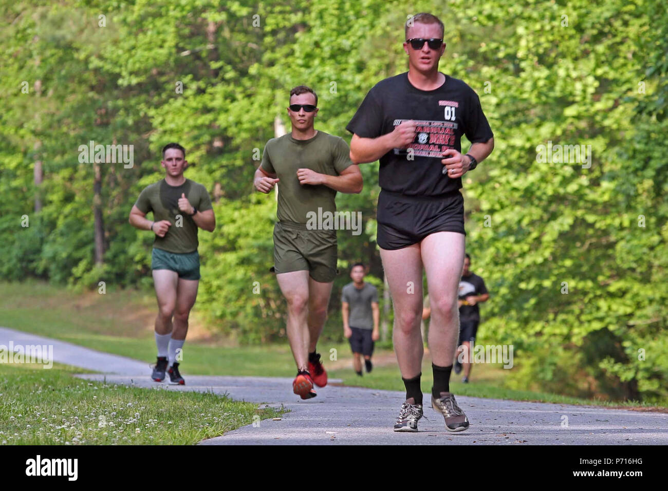 U.S. Marine Corps combat camera personnel from various units within the geographical area, participate in a memorial run to honor fallen combat camera members, Camp Lejeune, N.C., May 11, 2017. Cpl. Sara Medina, a combat photographer, and Lance Cpl. Jacob Hug, a combat videographer, gave the ultimate sacrifice while providing humanitarian assistance and disaster relief to remote villages in Nepal in dire need of aid during Operation Sahayogi Haat. Stock Photo