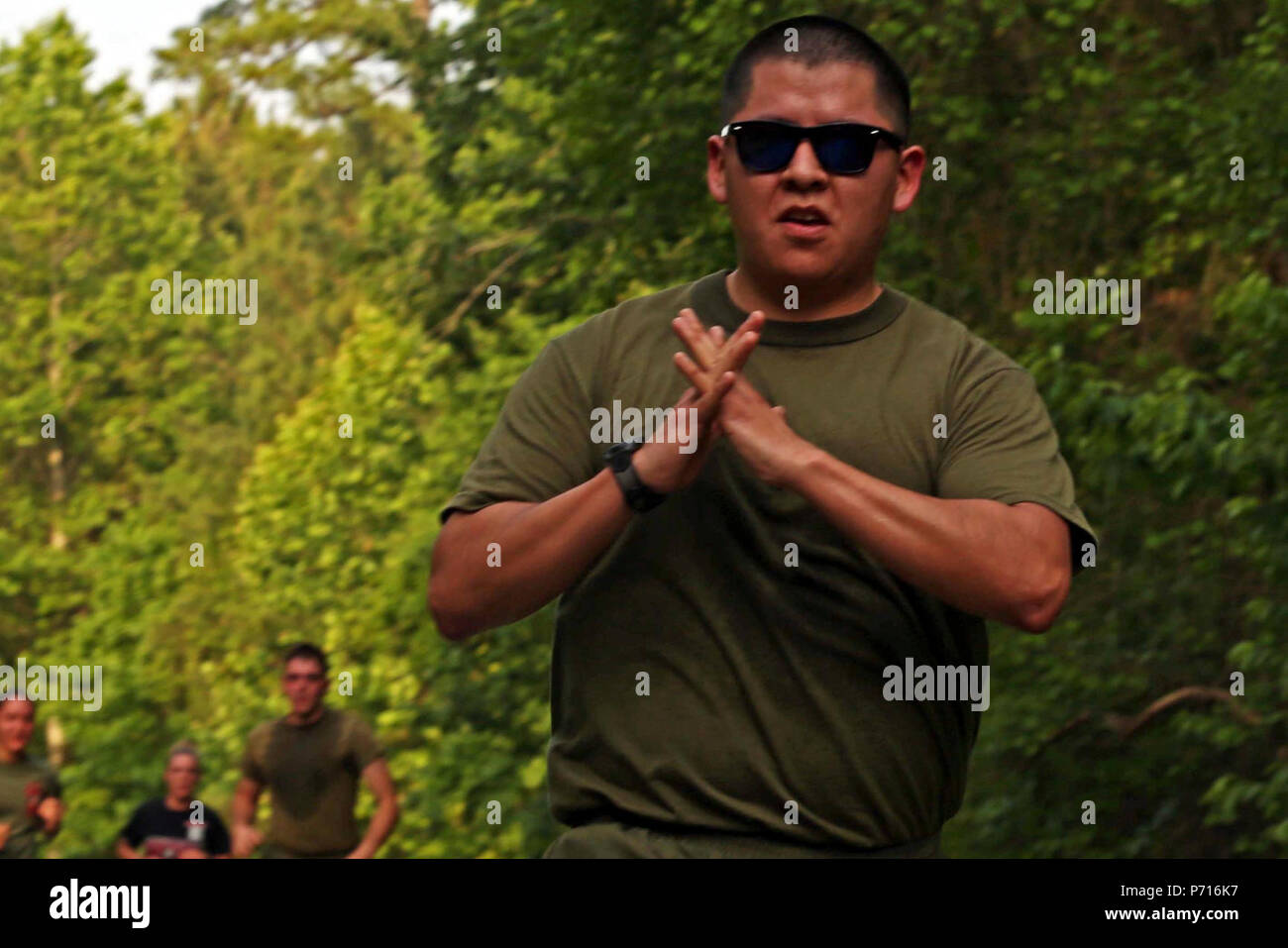 U.S. Marine Corps Sgt. Brandon Ponyah, combat videographer, Marine Corps Combat Service Support Schools, Camp Johnson, participates in a memorial run to honor fallen combat camera members, Camp Lejeune, N.C., May 11, 2017. Cpl. Sara Medina, a combat photographer, and Lance Cpl. Jacob Hug, a combat videographer, gave the ultimate sacrifice while providing humanitarian assistance and disaster relief to remote villages in Nepal in dire need of aid during Operation Sahayogi Haat. Stock Photo