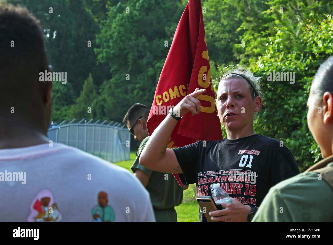 U.S. Marine Corps Sgt. Kassie McDole, combat videographer, 2nd Marine Division, gives her remarks after a memorial run to honor fallen combat camera members, Camp Lejeune, N.C., May 11, 2017. Cpl. Sara Medina, a combat photographer, and Lance Cpl. Jacob Hug, a combat videographer, gave the ultimate sacrifice while providing humanitarian assistance and disaster relief to remote villages in Nepal in dire need of aid during Operation Sahayogi Haat. Stock Photo