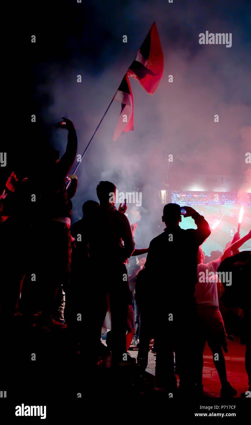 Belgrade, Serbia - June 27, 2018: Blurry crowd of young football fans watching Serbia  vs Brasil game in the World cup 2018 on the public huge screen  Stock Photo