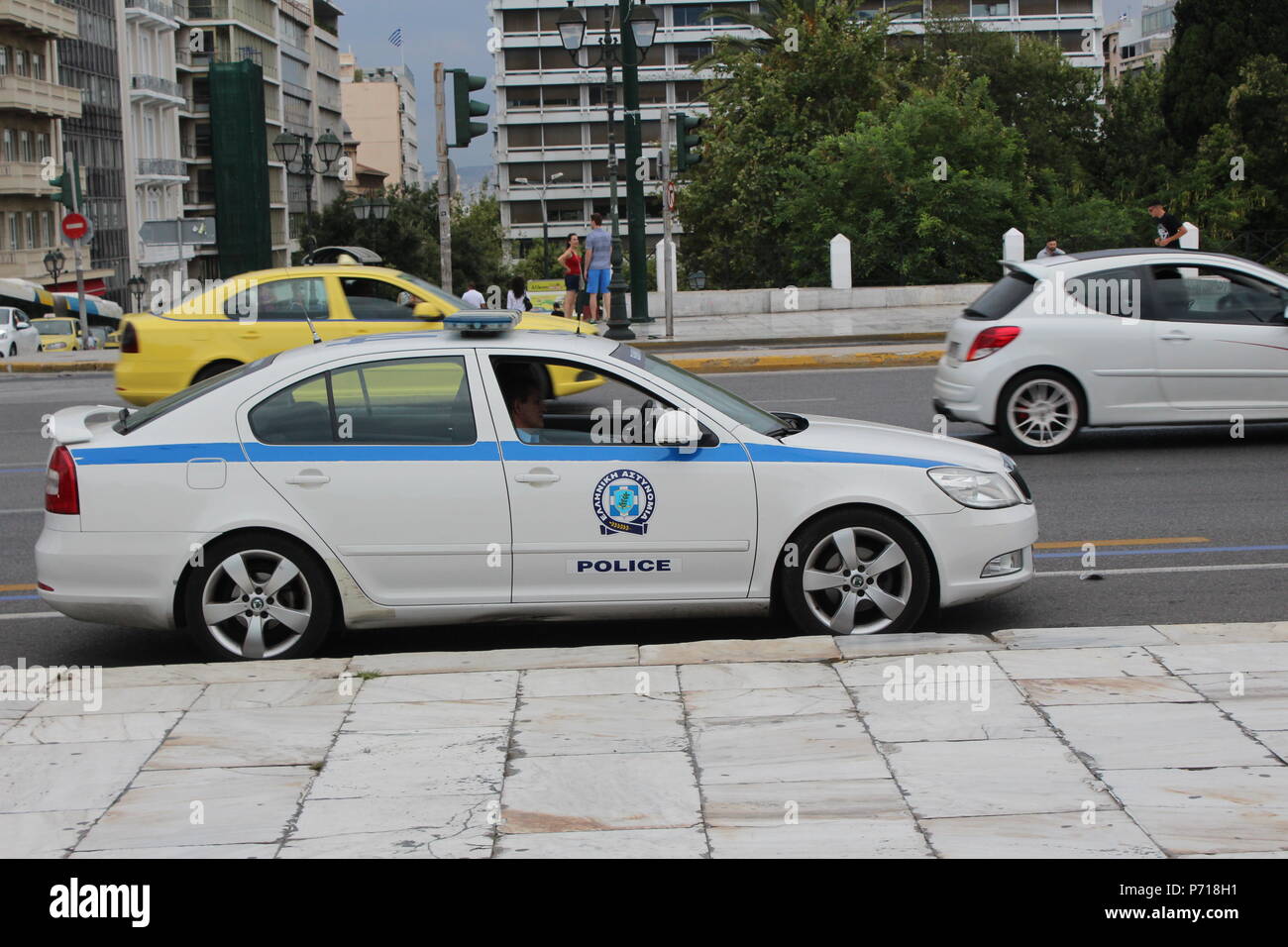 police car and taxi in athens street greece Stock Photo Alamy