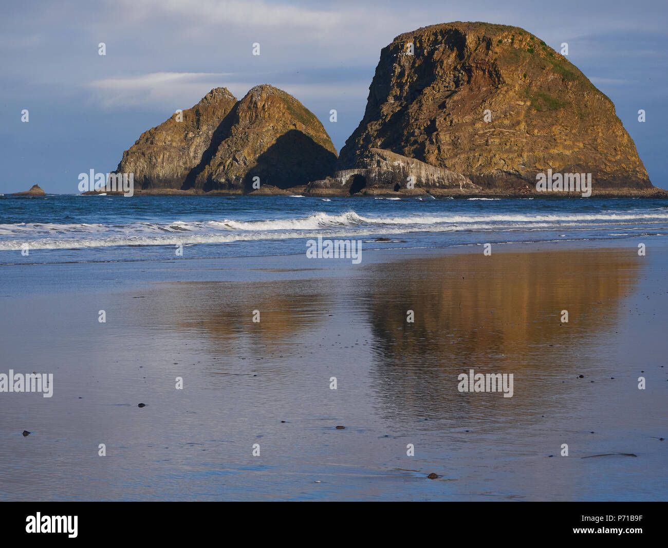 Three Arch National Wildlife Refuge reflecting in the water at low tide