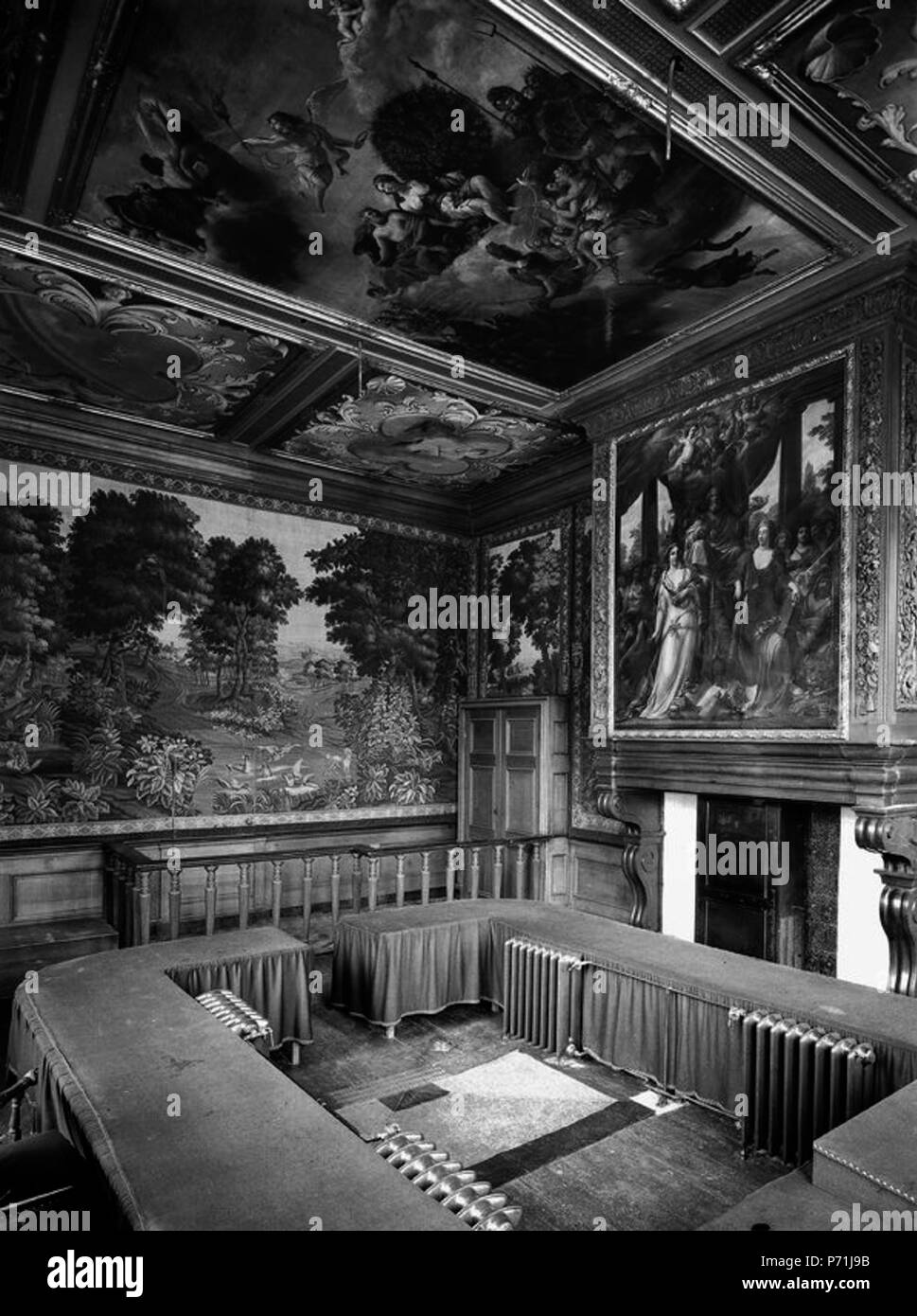 English: Maastricht, the Netherlands, town hall, so-called Collegekamer (formerly Council Chamber) with verdure tapestries, ordered in 1736 from François Guillaume van Verren in Oudenaarde (Belgium). Chimney piece by Theodore van der Schuer; ceiling paintings by J.B. Coclers, both early 18th c. (the latter replaced in 1965). Photo by G. de Hoog, 1915. . 4 December 2012, 01:50:52 14 Stadhuis Maastricht, Collegekamer, GdeHoog, 1915 Stock Photo