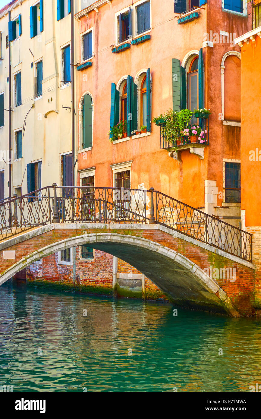Venetian view with small bridge and old houses by canal, Venice Stock Photo