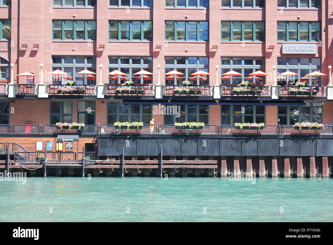 Downtown riverside building and cafe along Chicago's scenic and modern downtown river walk along the Chicago River and Wacker Drive. Stock Photo