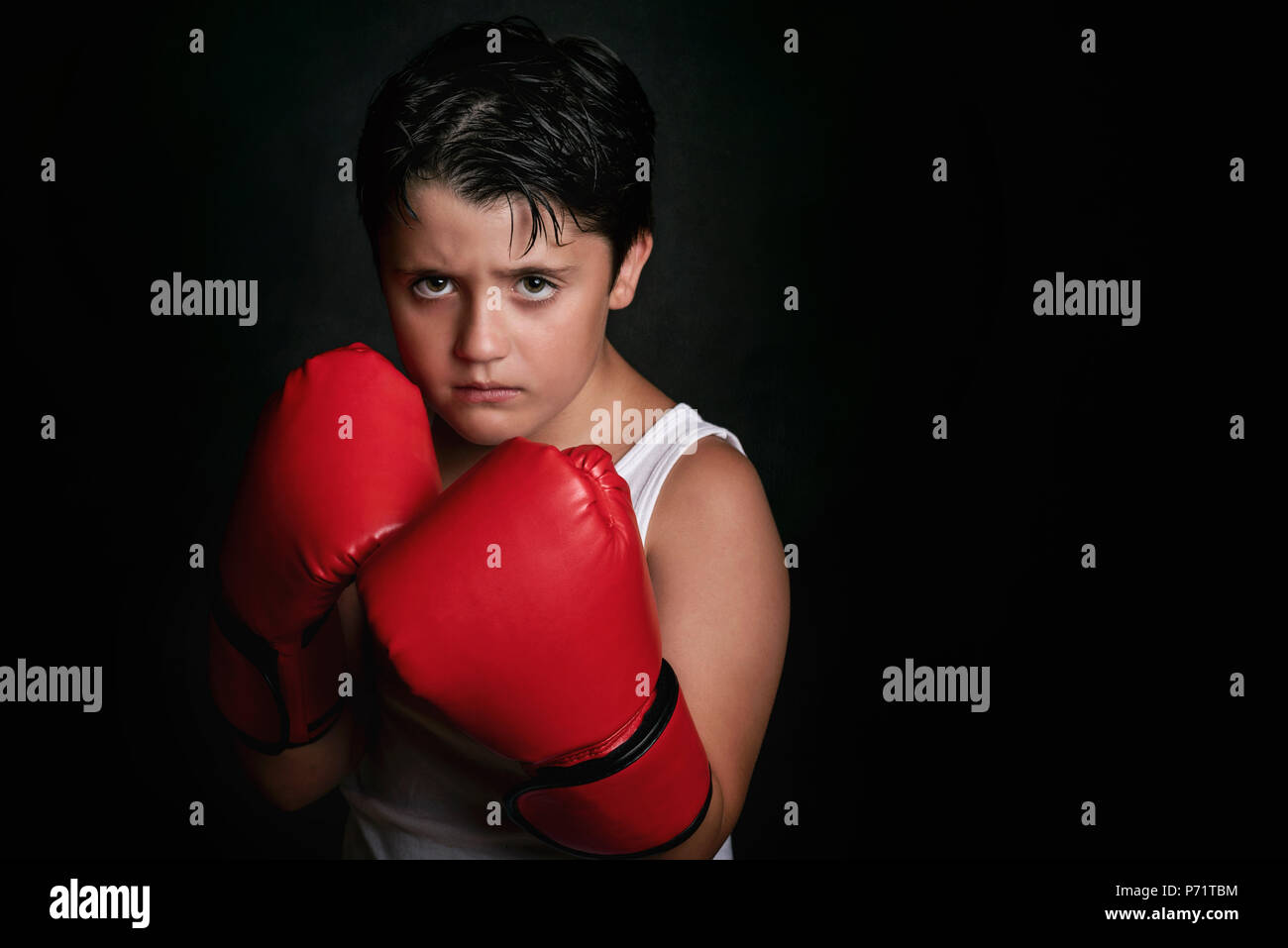 little boy with boxing gloves on black background Stock Photo Alamy