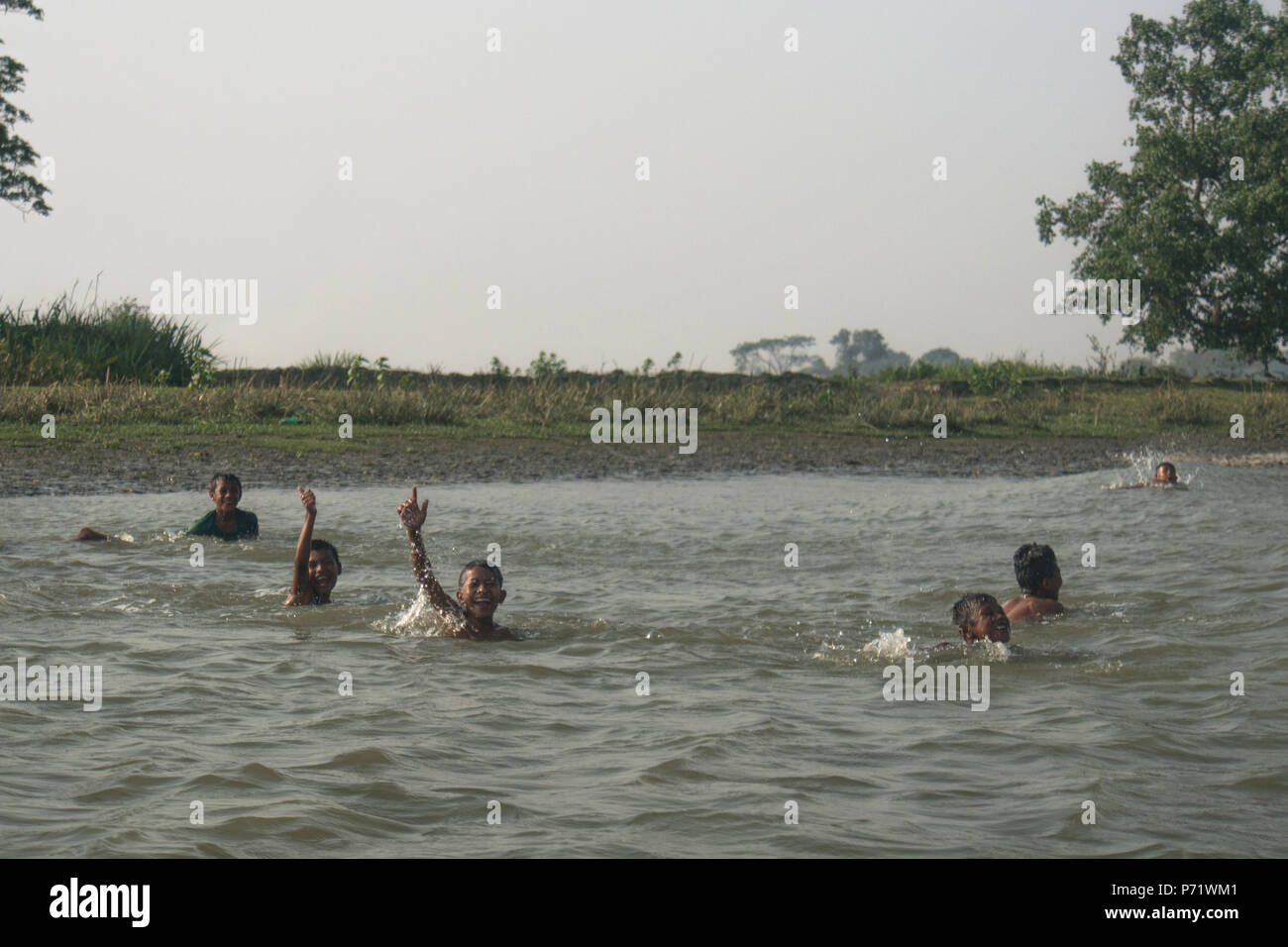 Boys were playing in the river, Mrauk u Myanmar Stock Photo