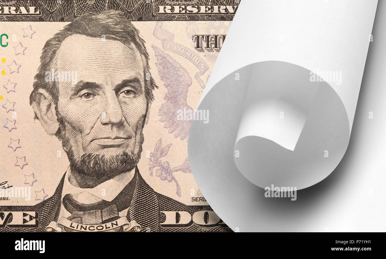 Five Dollar Bill with White Scroll of Paper. Stock Photo